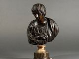 a bronze bust of a woman holding a baby on a pedestal
