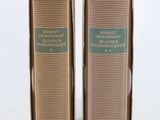 pair of two brown boxes with labels on them on a white surface