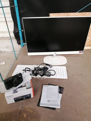 an image of a desk with a computer monitor, keyboard, mouse, and other items