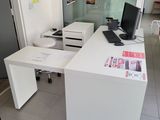 a white desk with a computer on it in a room