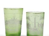 pair of green glass tumblers with a picture of a city on them
