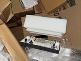 a pile of boxes and a remote control on the floor