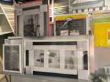 many framed pictures on a shelf in a store