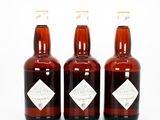 three bottles of beer sitting next to each other on a white surface
