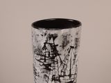 a black and white picture of a vase with a ship on it