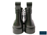 a pair of black boots that are on a white surface
