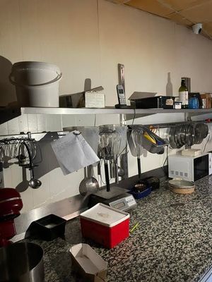a kitchen counter with a bunch of utensils on it