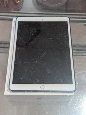 a tablet computer sitting on top of a glass table