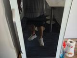 a person standing in front of a mirror in a room