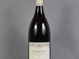the bottle of wine is sitting on the table on the table