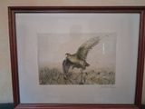 painting of a bird flying over a field of grass in a wooden frame