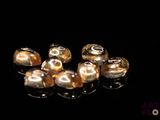 a lot of gold colored beads on a black surface
