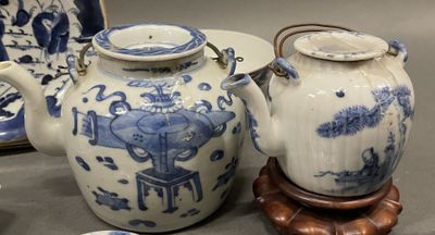 two blue and white vases and a plate on a table