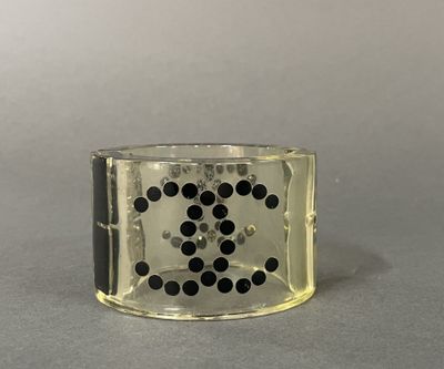 a close up of a ring with black dots on it