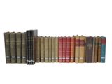 many books that are lined up together on a shelf