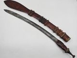 an old knife with a wooden handle sitting on top of a white surface