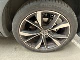 a close up of a tire on a car in a parking lot