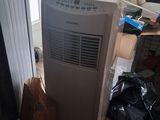 a small air conditioner sitting in the corner of a room