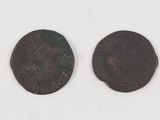 two roman coins, one of which has a head and the other of which has a face