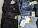 several pairs of men ' s jeans are laid out on a table