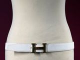 a close up of a white belt on a mannequin