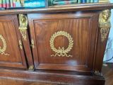 a large wooden cabinet with a wreath on the front