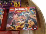 two boxes of lego ninja action figures on a table