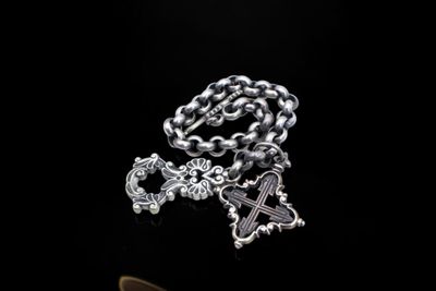 a silver chain with a cross and a cross on it
