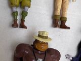 five action figures that are on a white surface