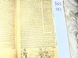 an open book on a bed with a price tag on it