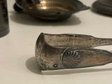 a spoon and spoon rest on a table with other spoons