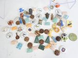 many different types of buttons and magnets on the table