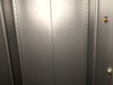 a metal door that is open in a room