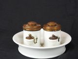 two salt and pepper shakers on a white plate