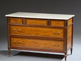 an antique chest of drawers with marble top and brass handles