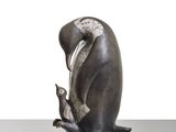 a statue of a bird that is sitting on top of a table