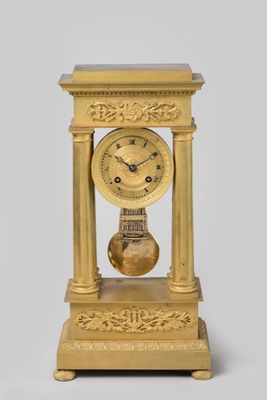 a gold clock that is sitting on top of a table