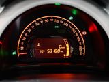 the dashboard of a car with a digital clock on it ' s display