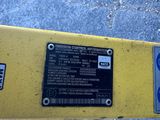 a yellow parking meter with a blue sticker on it