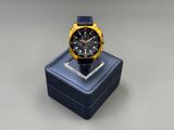a watch sitting on top of a blue box on a table