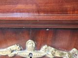 a close up of a wooden cabinet with a metal handle