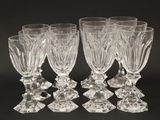 six clear wine glasses sitting on top of a black table