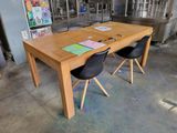 a wooden table with two black chairs in front of it