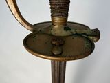 a close up of a metal object with a wooden handle