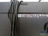 a close up of a laptop with a cord attached to it