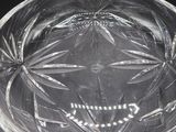 a clear glass bowl with a design on it