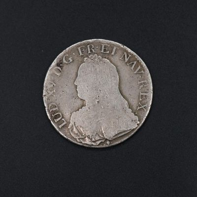 a close up of a coin on a black surface