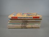 several children ' s books stacked on top of each other