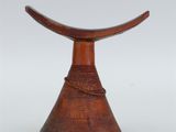 an image of a wooden stool with a curved top