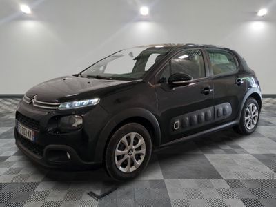 the black citrole is parked on a checkered tile floor